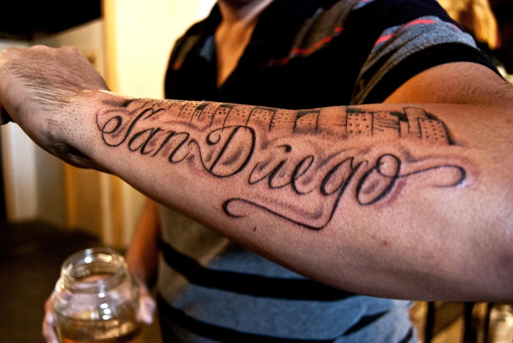 Image of tatto with the script San Diego under downtown skyline
